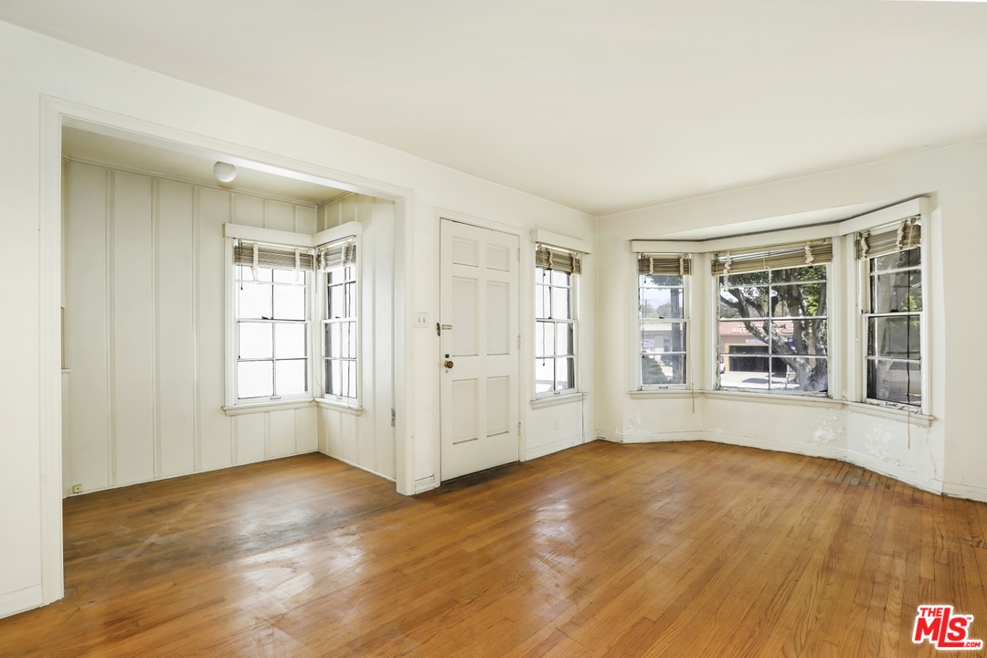 4053 Verdugo Road Los Angeles, CA 90065 - Photo 4 of 45 an empty room with wooden floor and windows