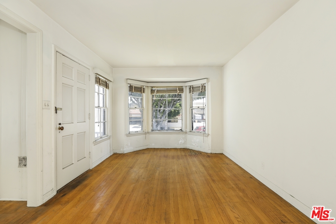 4053 Verdugo Road Los Angeles, CA 90065 - Photo 5 of 45 a view of an empty room with wooden floor and a window