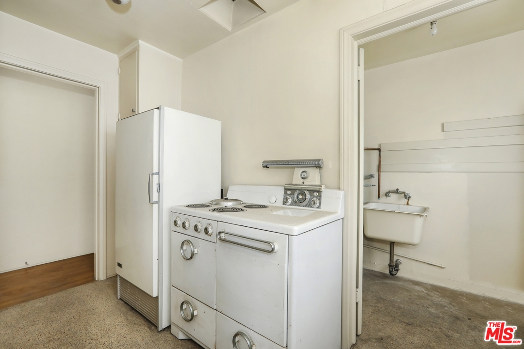4053 Verdugo Road Los Angeles, CA 90065 - Photo 7 of 45 a view of washer and dryer with kitchen in the background