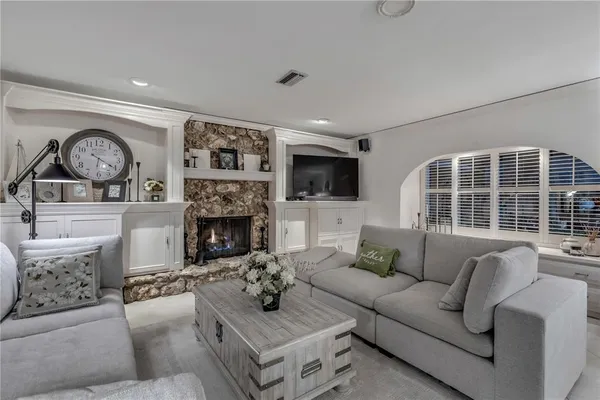 a kitchen with white cabinets and window
