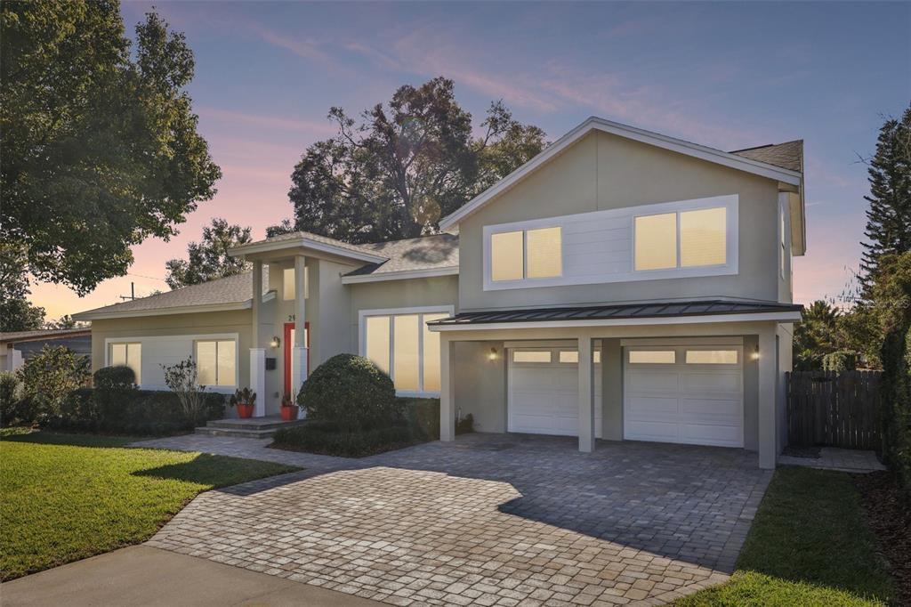 a front view of a house with a yard and garage