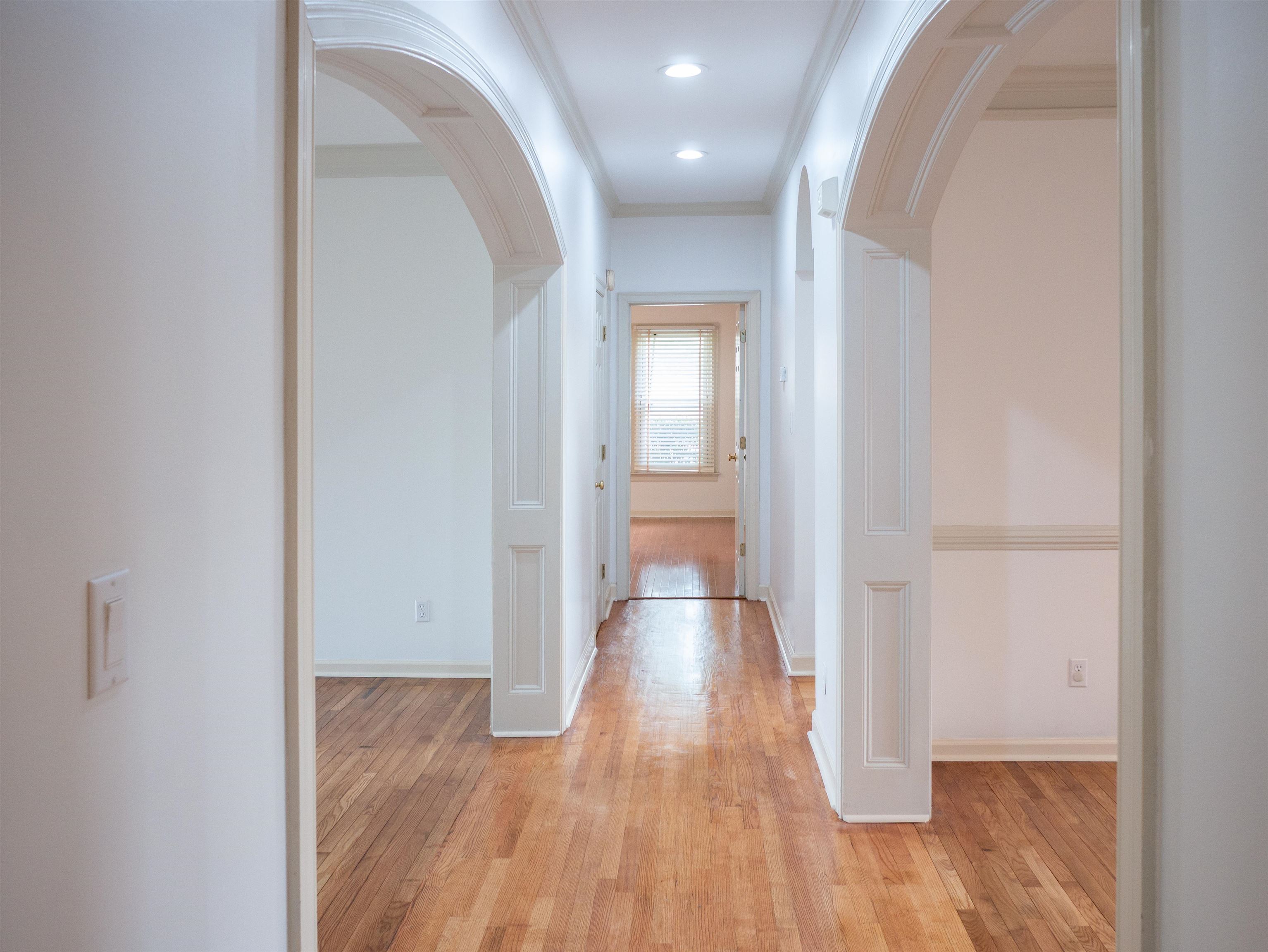 1923 Swynford Lane Collierville, TN 38017 - Photo 14 of 35 Hall featuring arched walkways, light wood-type flooring, and ornamental molding