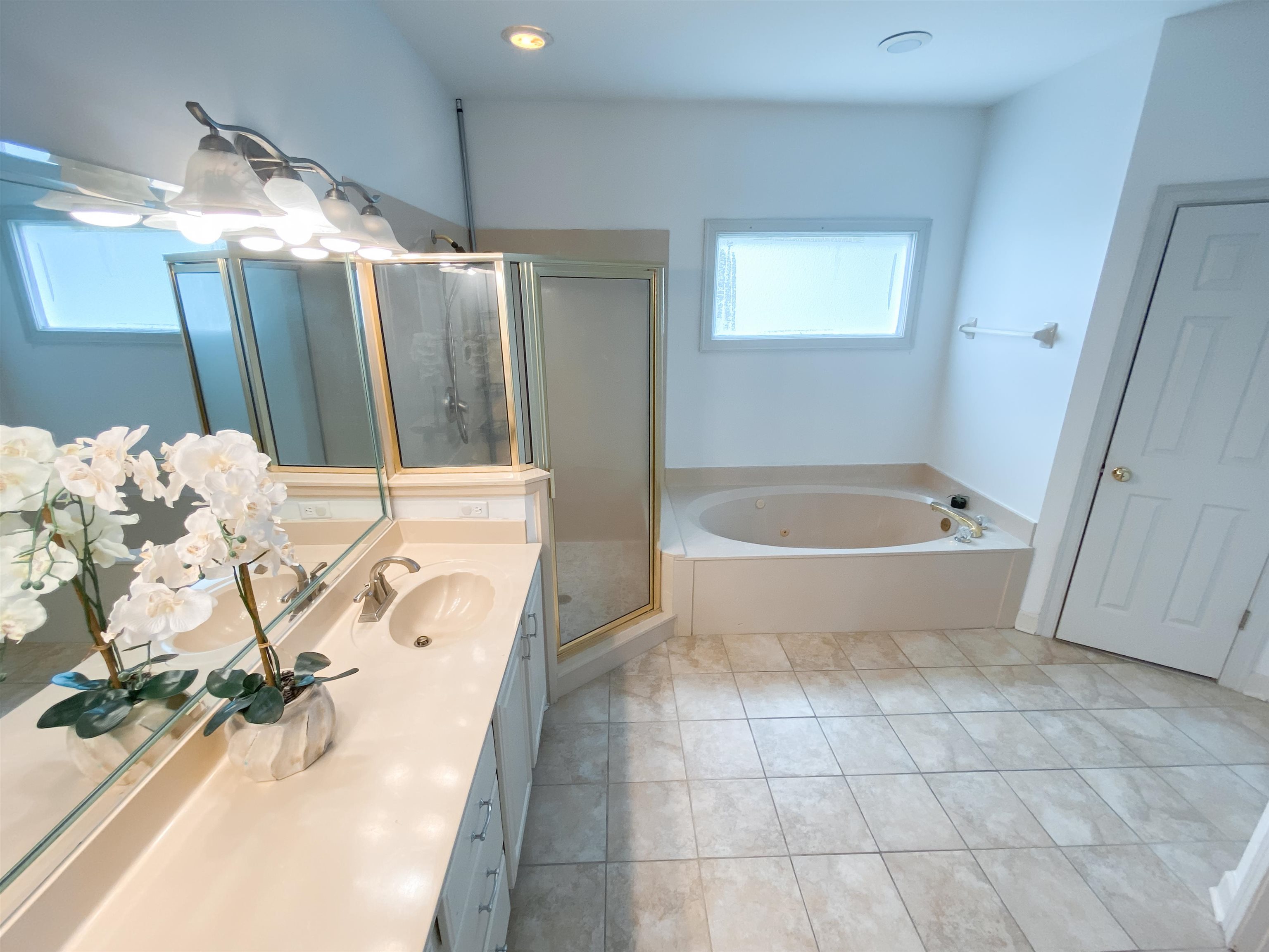 1923 Swynford Lane Collierville, TN 38017 - Photo 17 of 35 Bathroom with vanity, a garden tub, a stall shower, and tile patterned floors