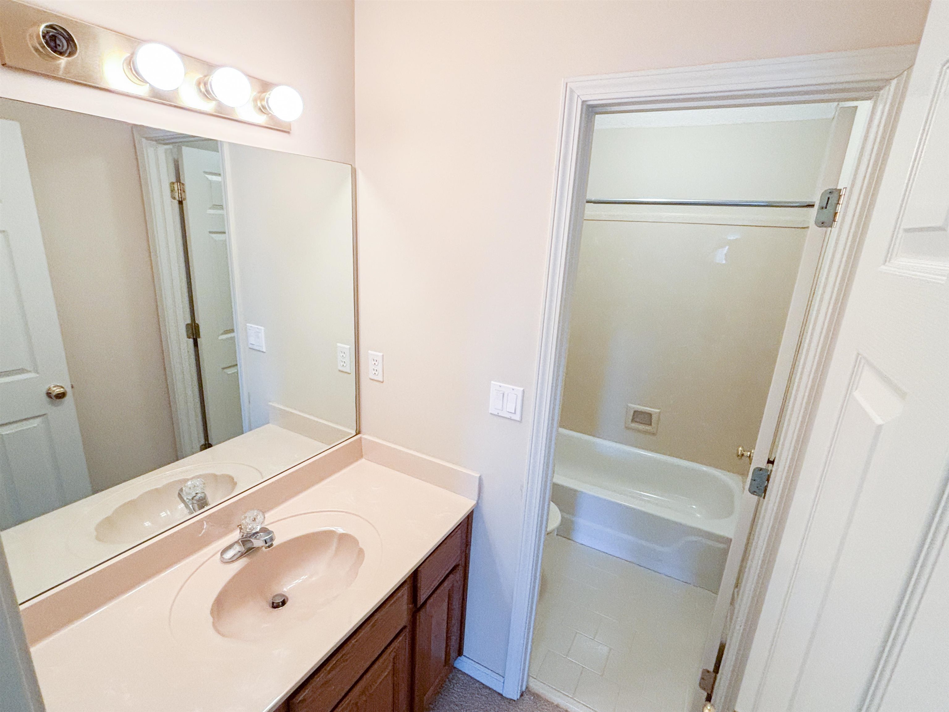 1923 Swynford Lane Collierville, TN 38017 - Photo 26 of 35 a bathroom with a sink a mirror a vanity and shower
