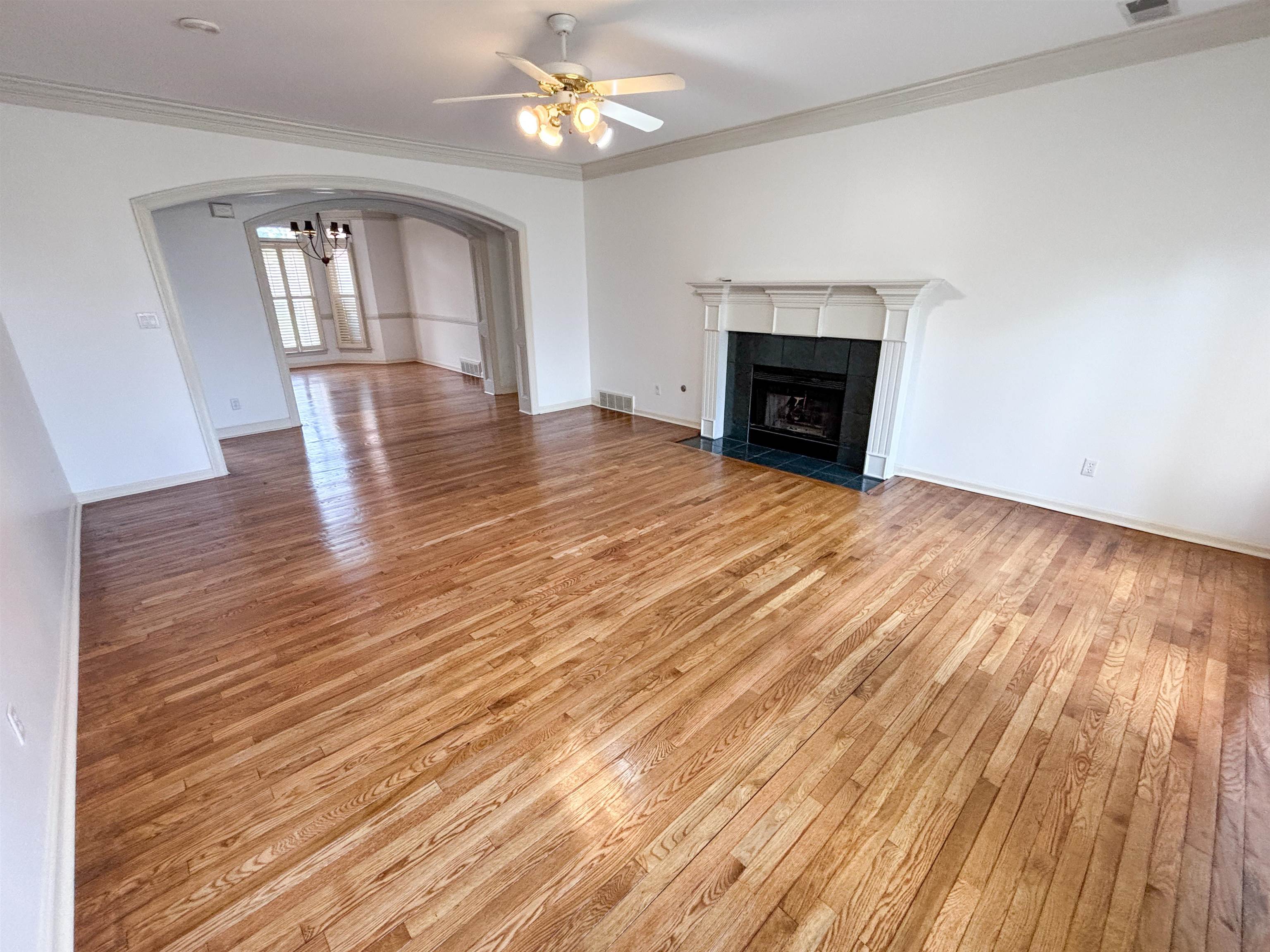 1923 Swynford Lane Collierville, TN 38017 - Photo 9 of 35 a view of empty room with wooden floor and fireplace