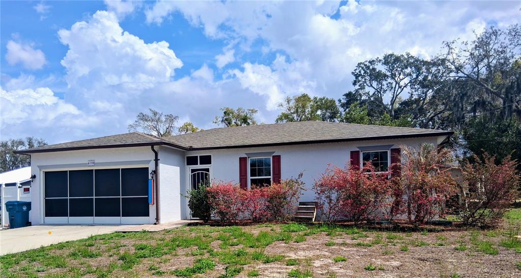 4096 Thunderbird Avenue Spring Hill, FL 34606 - Photo 1 of 20 front view of a house with a garden