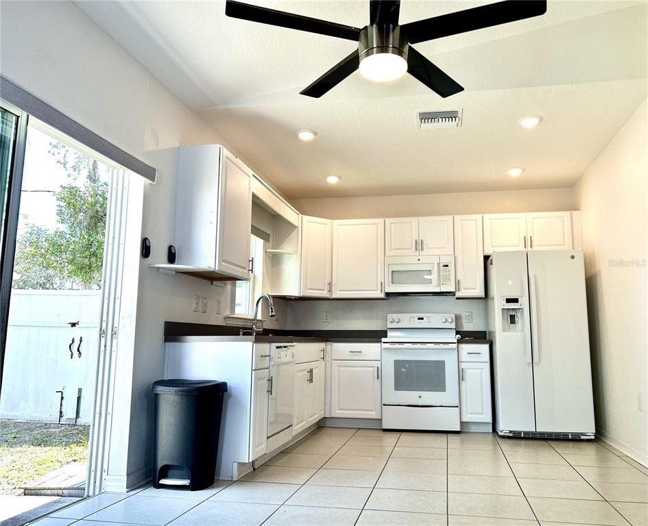 4096 Thunderbird Avenue Spring Hill, FL 34606 - Photo 16 of 20 a kitchen with stainless steel appliances a refrigerator sink and cabinets