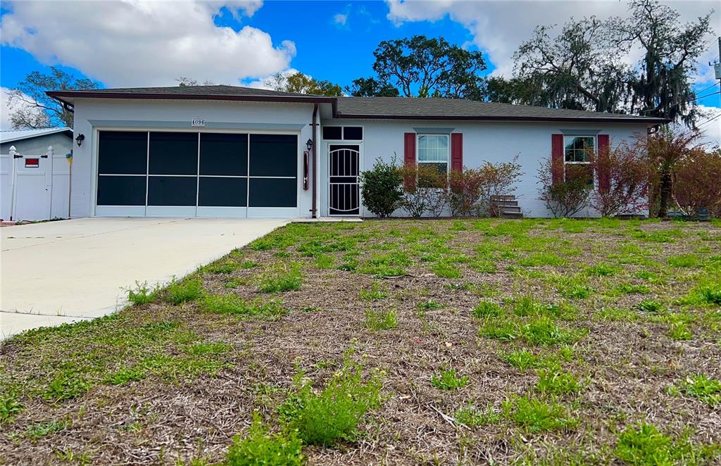 4096 Thunderbird Avenue Spring Hill, FL 34606 - Photo 20 of 20 a front view of a house with garden