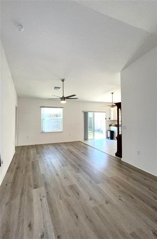4096 Thunderbird Avenue Spring Hill, FL 34606 - Photo 7 of 20 a view of empty room with wooden floor