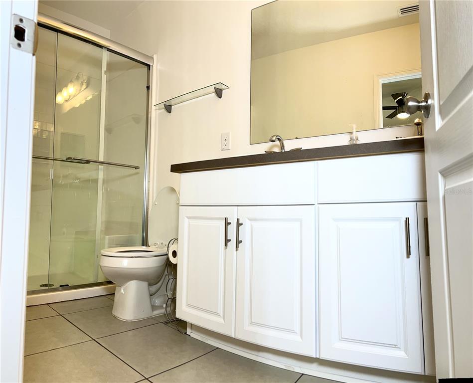 4096 Thunderbird Avenue Spring Hill, FL 34606 - Photo 9 of 20 a bathroom with a toilet and a shower