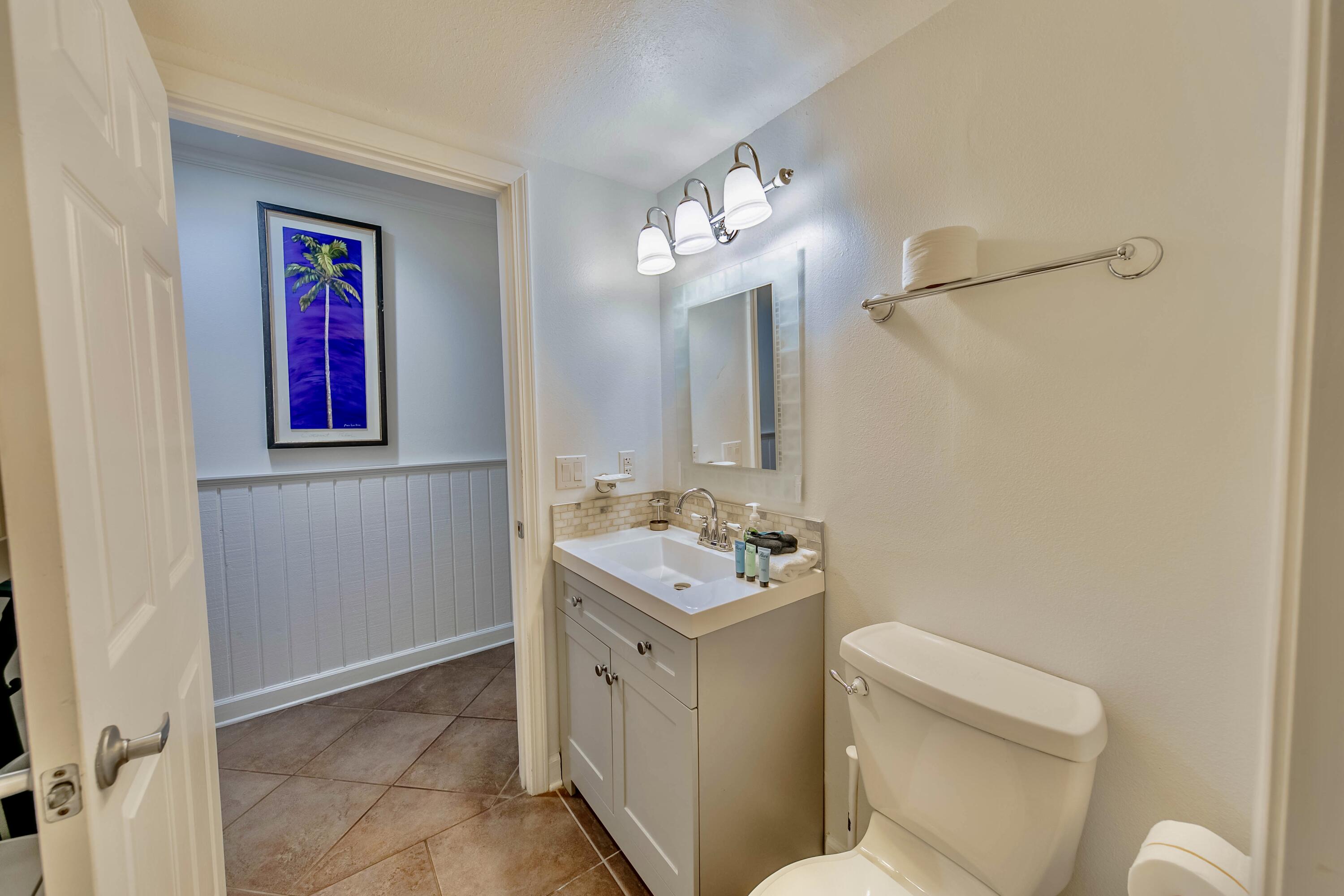 595 Eastern Lake Road, Unit 103 Santa Rosa Beach, FL 32459 - Photo 29 of 30 a bathroom with a toilet sink and mirror