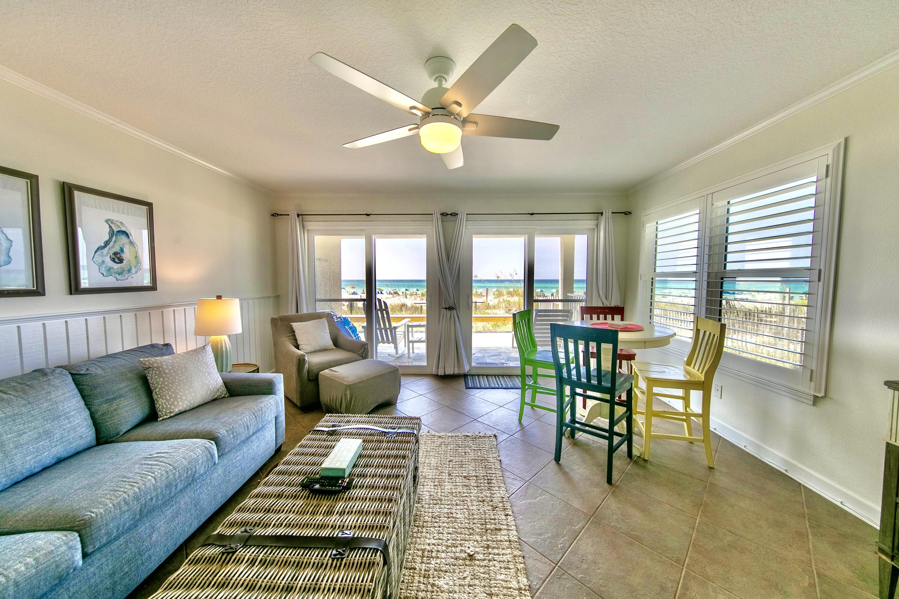 595 Eastern Lake Road, Unit 103 Santa Rosa Beach, FL 32459 - Photo 7 of 30 a living room with furniture and a dining table with garden view