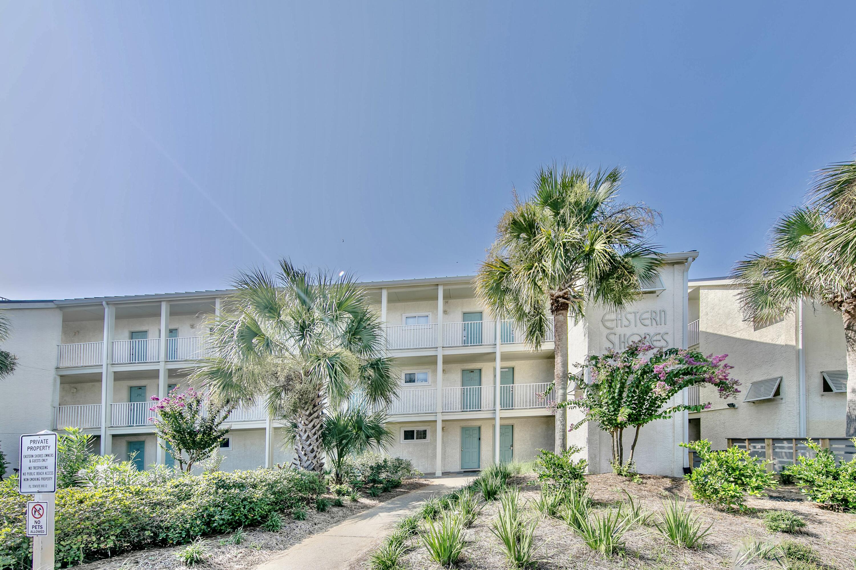 595 Eastern Lake Road, Unit 103 Santa Rosa Beach, FL 32459 - Photo 10 of 30 a house with a flower garden