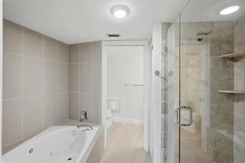 a bathroom with a bathtub and a shower