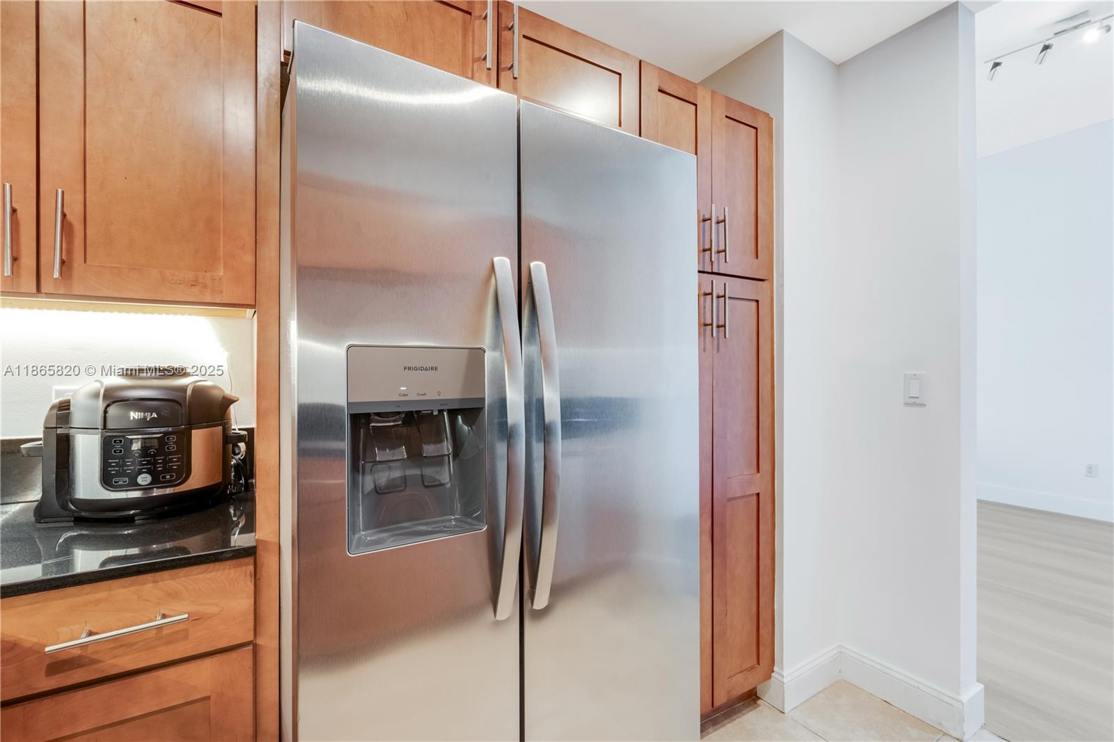 8395 Southwest 73rd Avenue, Unit 517 Miami, FL 33143 - Photo 13 of 27 a kitchen with a refrigerator and a sink