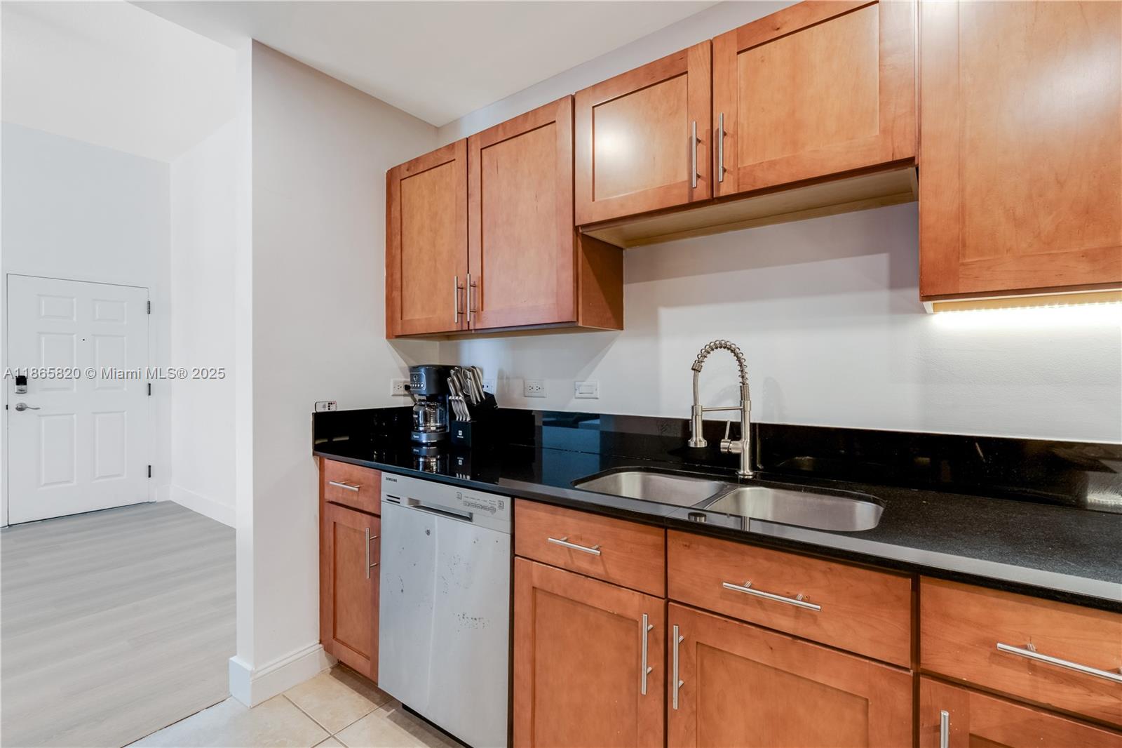 8395 Southwest 73rd Avenue, Unit 517 Miami, FL 33143 - Photo 14 of 27 a kitchen with granite countertop a sink and cabinets