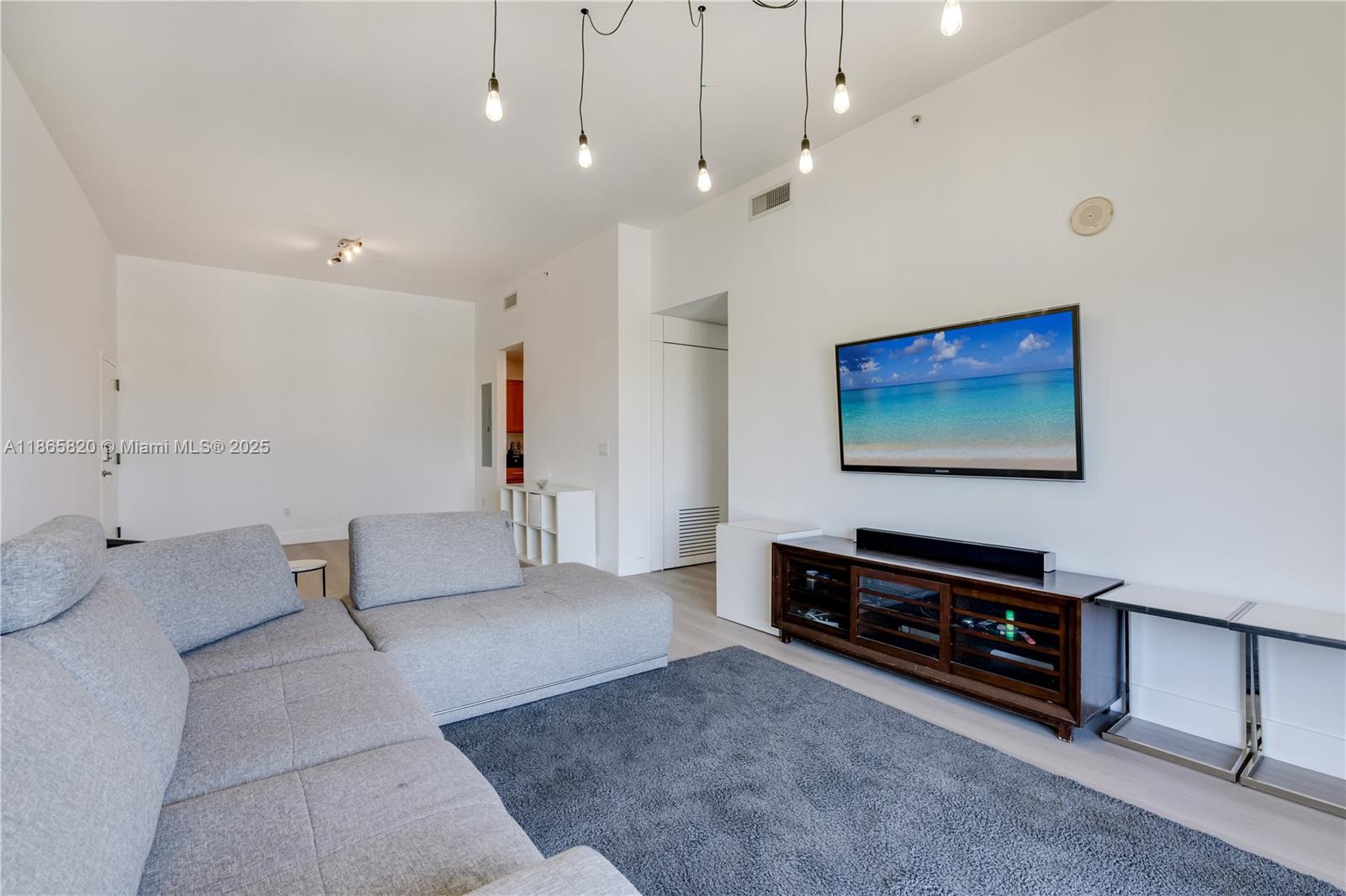 8395 Southwest 73rd Avenue, Unit 517 Miami, FL 33143 - Photo 15 of 27 a living room with furniture and a flat screen tv