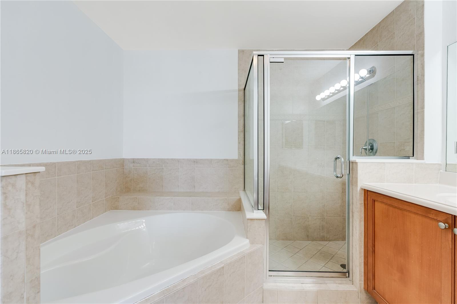 8395 Southwest 73rd Avenue, Unit 517 Miami, FL 33143 - Photo 19 of 27 a bathroom with a bathtub and a shower