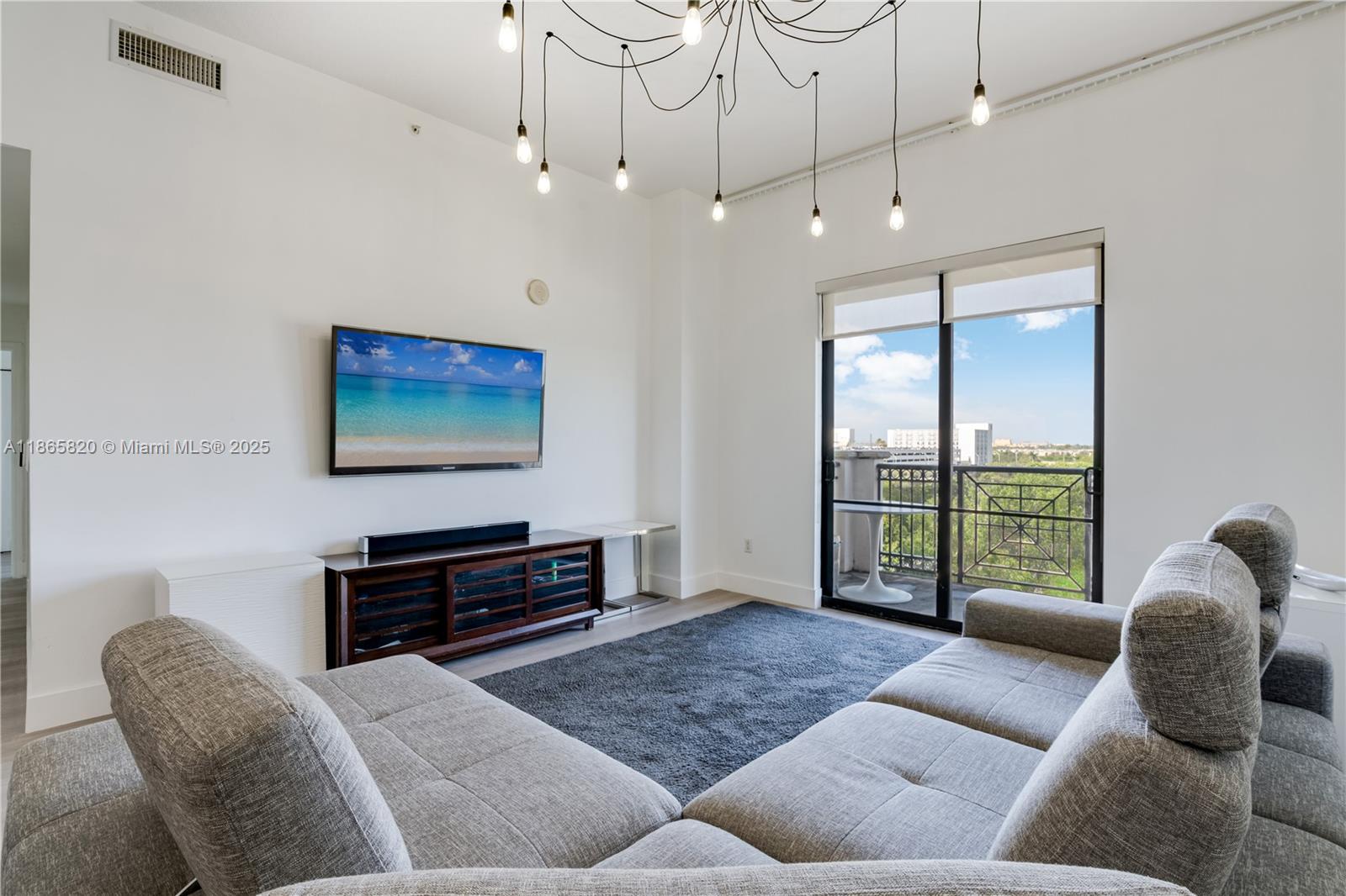 8395 Southwest 73rd Avenue, Unit 517 Miami, FL 33143 - Photo 3 of 27 a living room with furniture and a flat screen tv