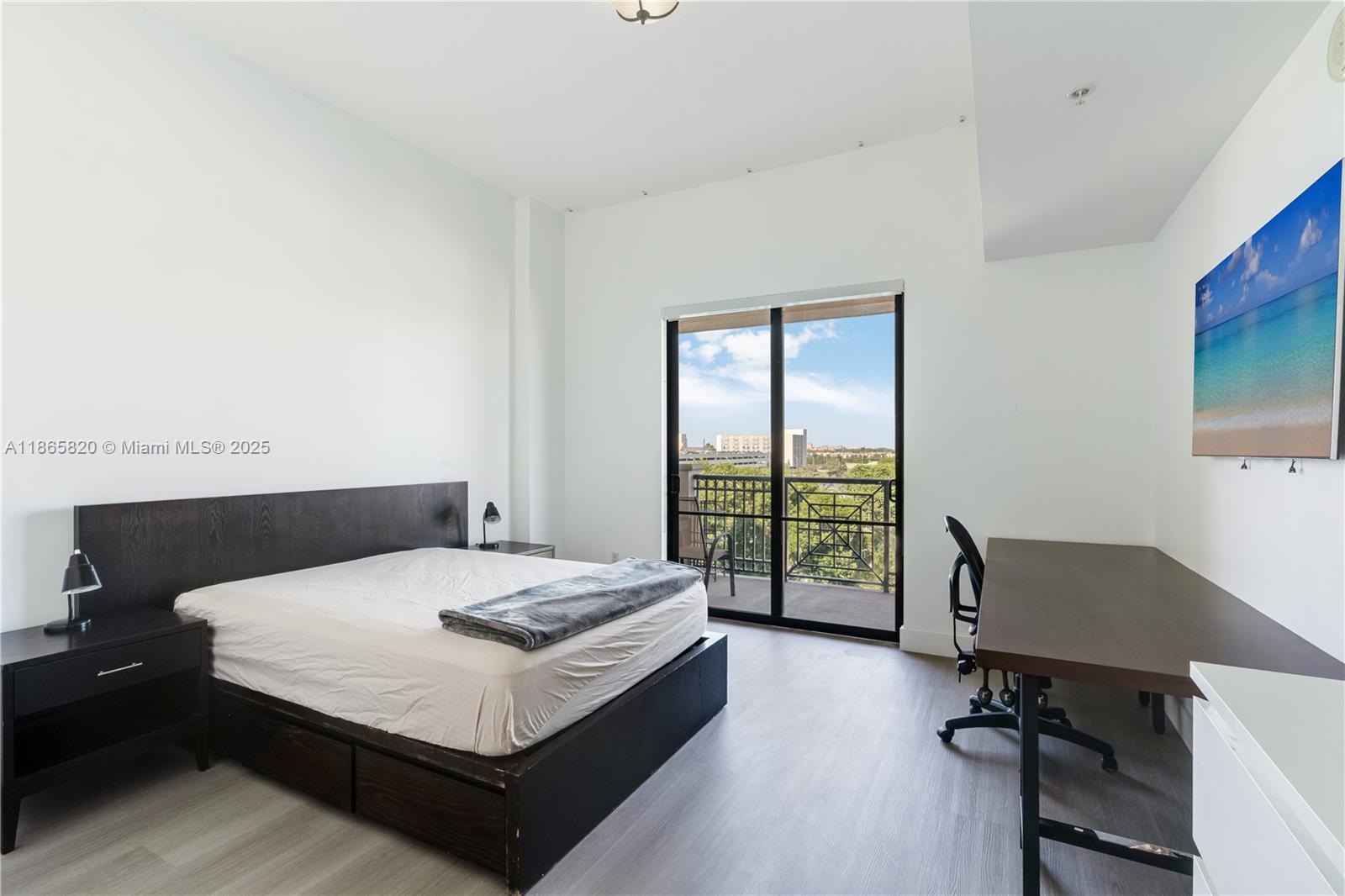 8395 Southwest 73rd Avenue, Unit 517 Miami, FL 33143 - Photo 4 of 27 a bedroom with a bed and a desk