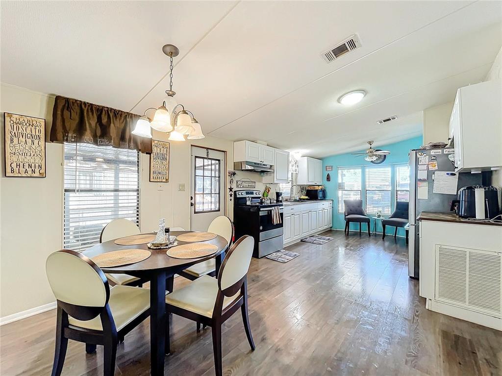 6 Cayman Circle Umatilla, FL 32784 - Photo 13 of 34 a view of a dining room with furniture and wooden floor