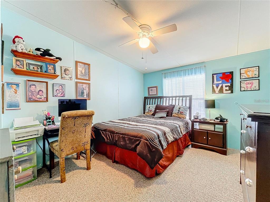 6 Cayman Circle Umatilla, FL 32784 - Photo 18 of 34 a bedroom with a bed and a desk