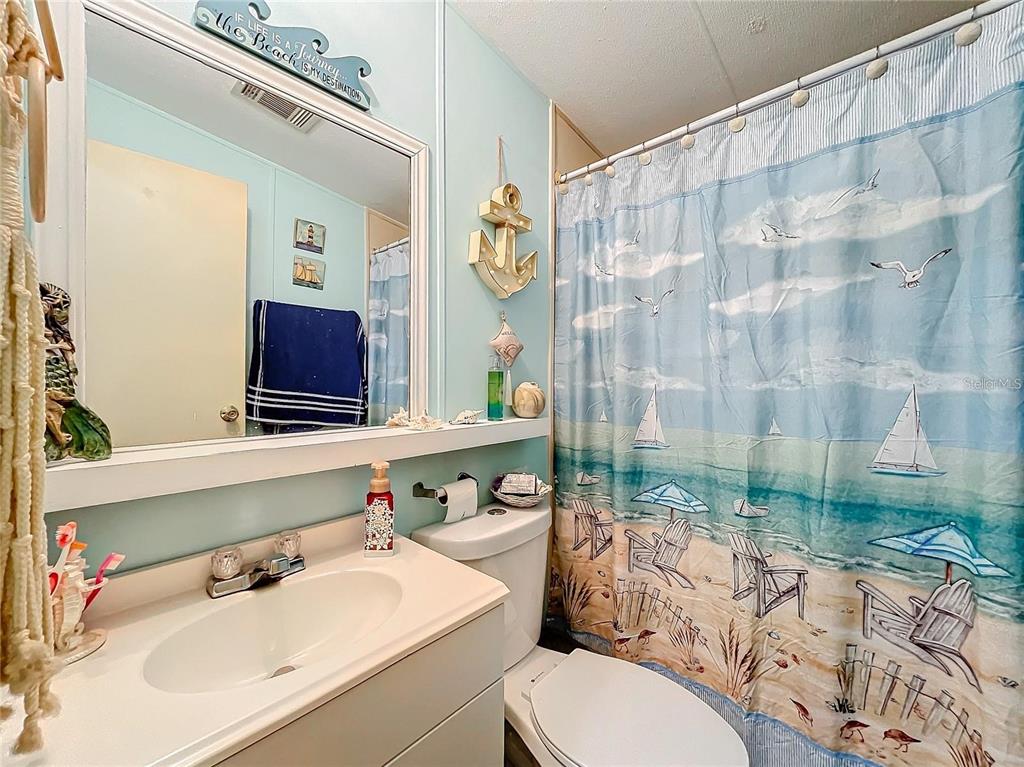 6 Cayman Circle Umatilla, FL 32784 - Photo 20 of 34 a bathroom with a sink vanity mirror and tub