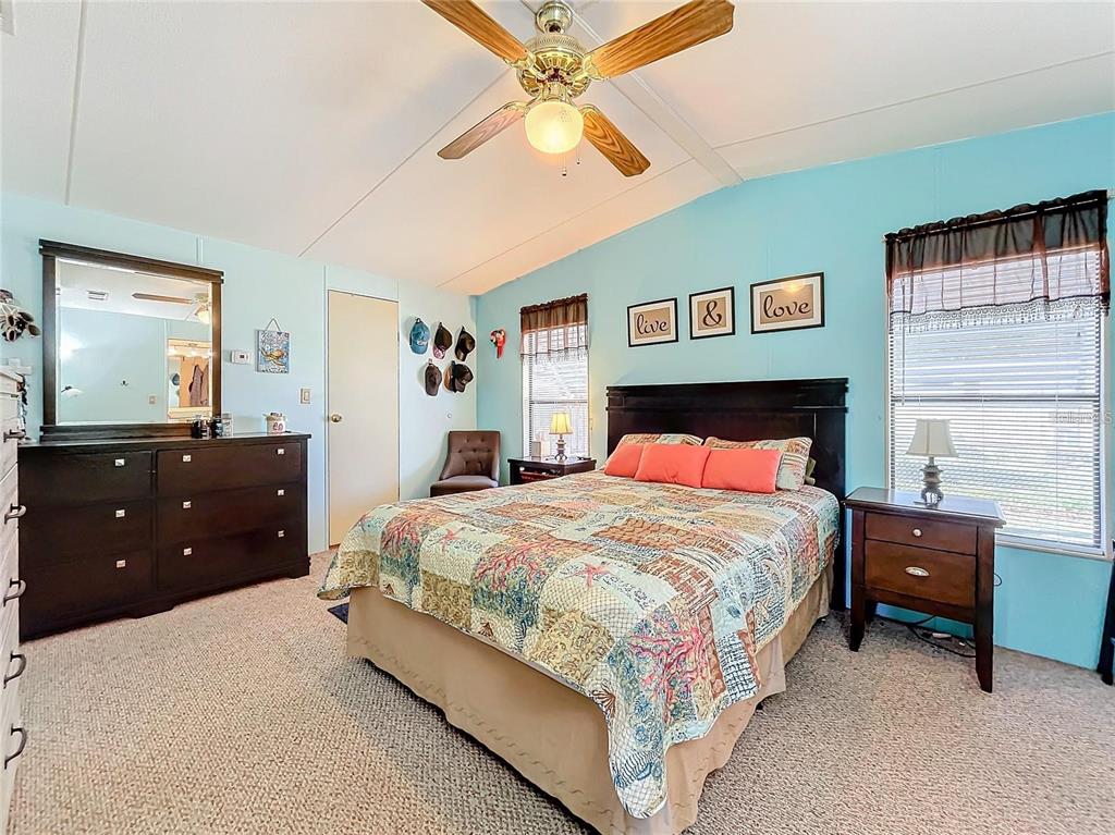 6 Cayman Circle Umatilla, FL 32784 - Photo 21 of 34 a bedroom with a bed and a dresser