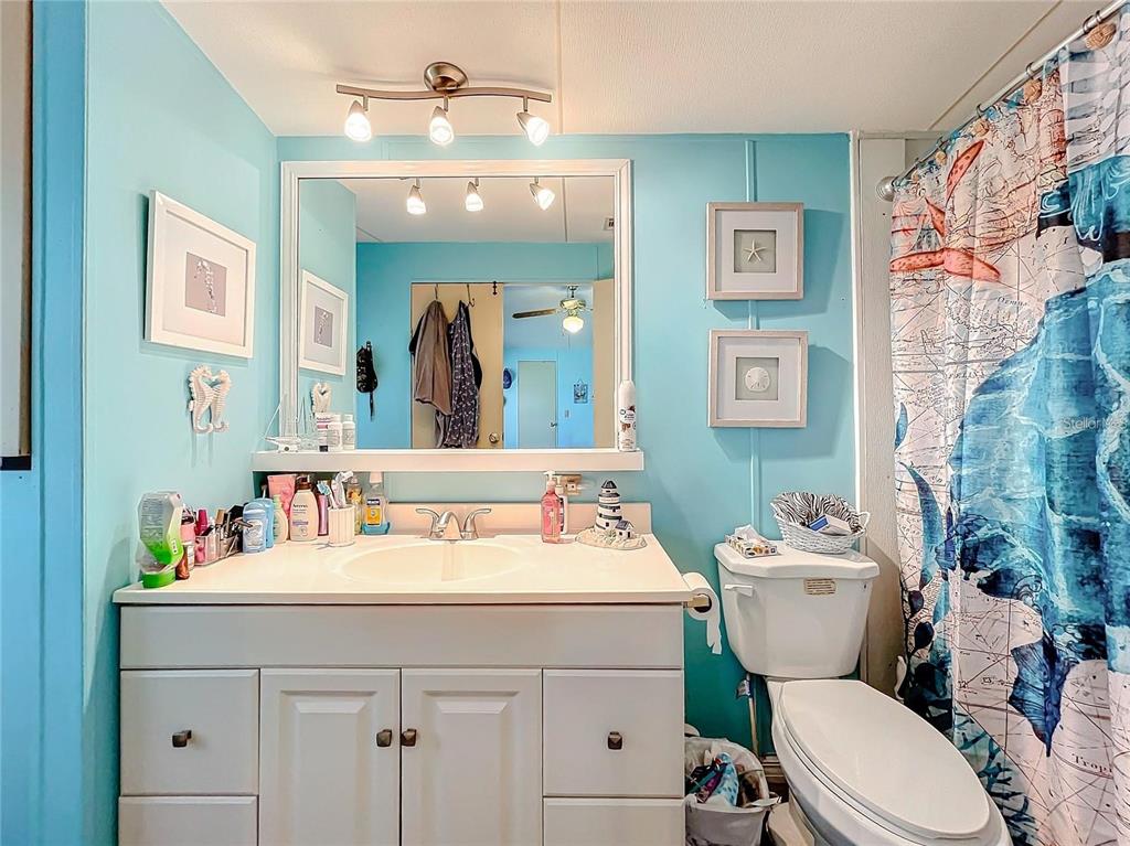 6 Cayman Circle Umatilla, FL 32784 - Photo 23 of 34 a bathroom with a toilet a sink and a mirror