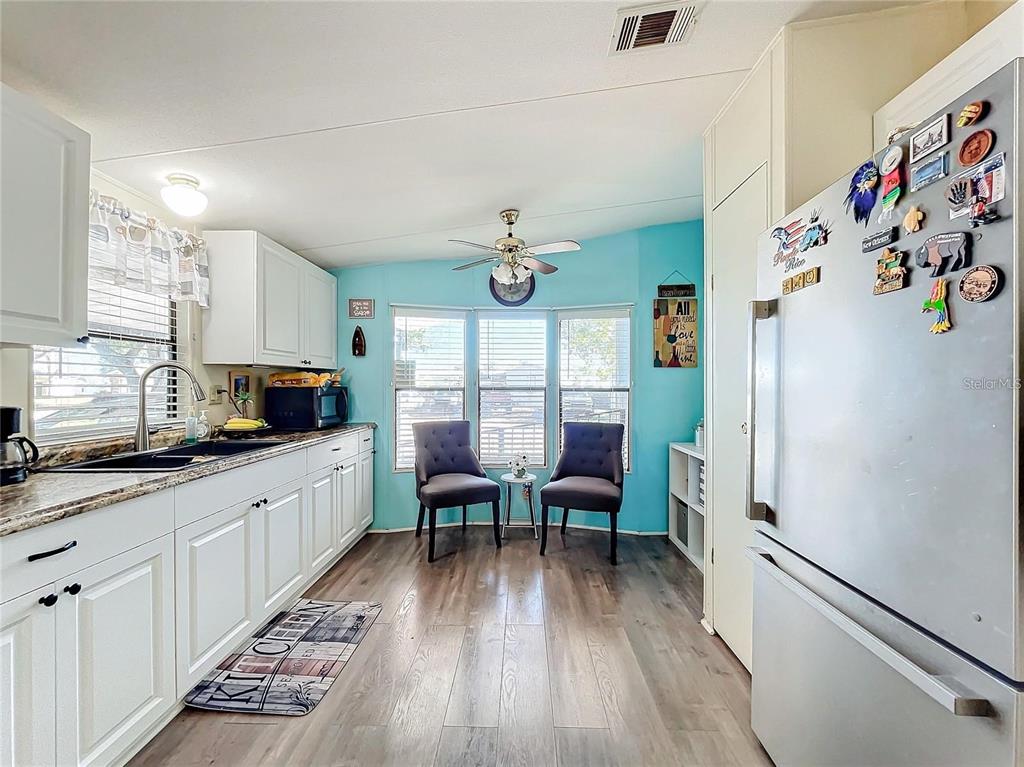 6 Cayman Circle Umatilla, FL 32784 - Photo 8 of 34 a kitchen with granite countertop appliances a sink and a refrigerator