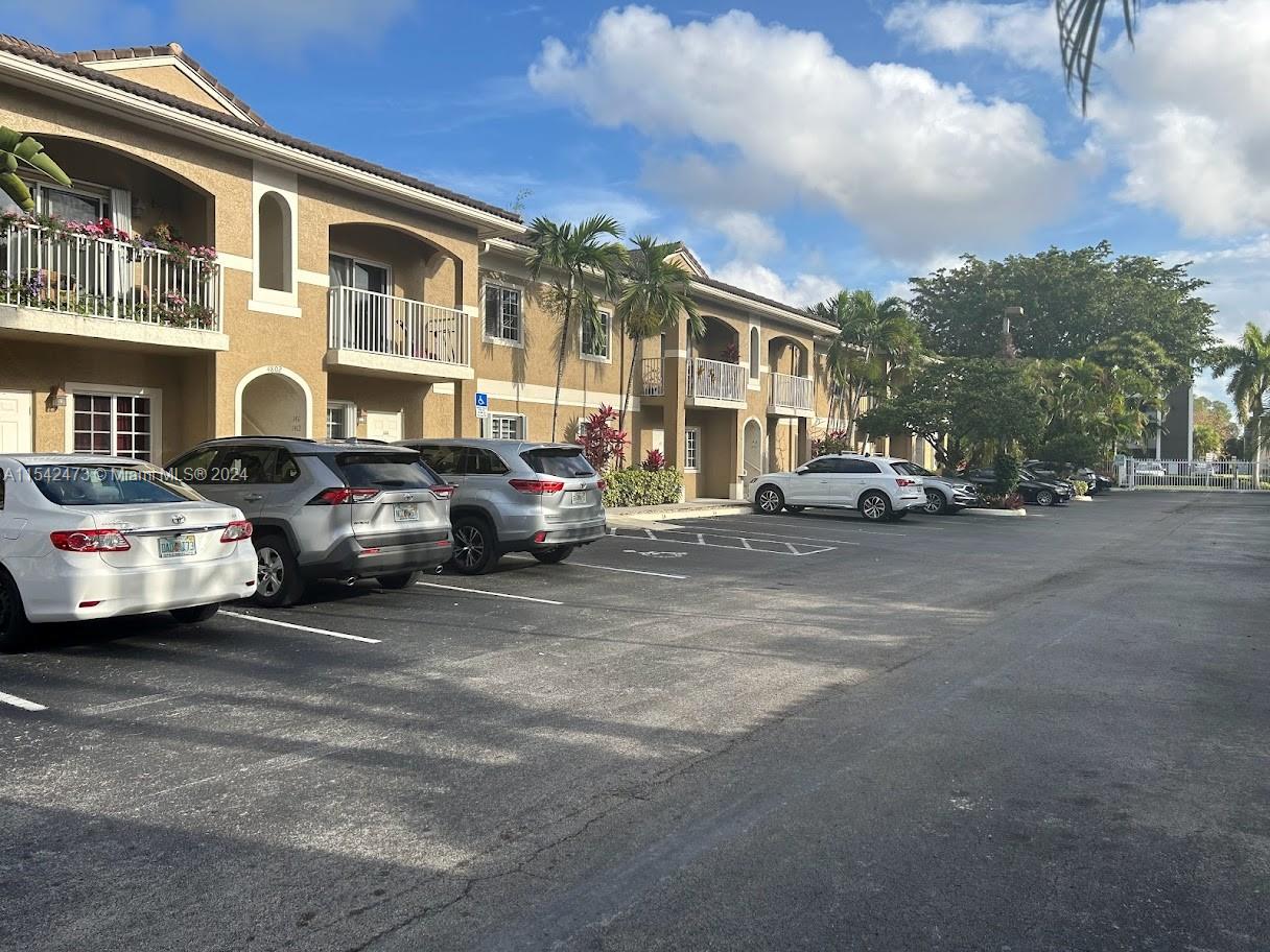 a city street lined with parked cars and buildings