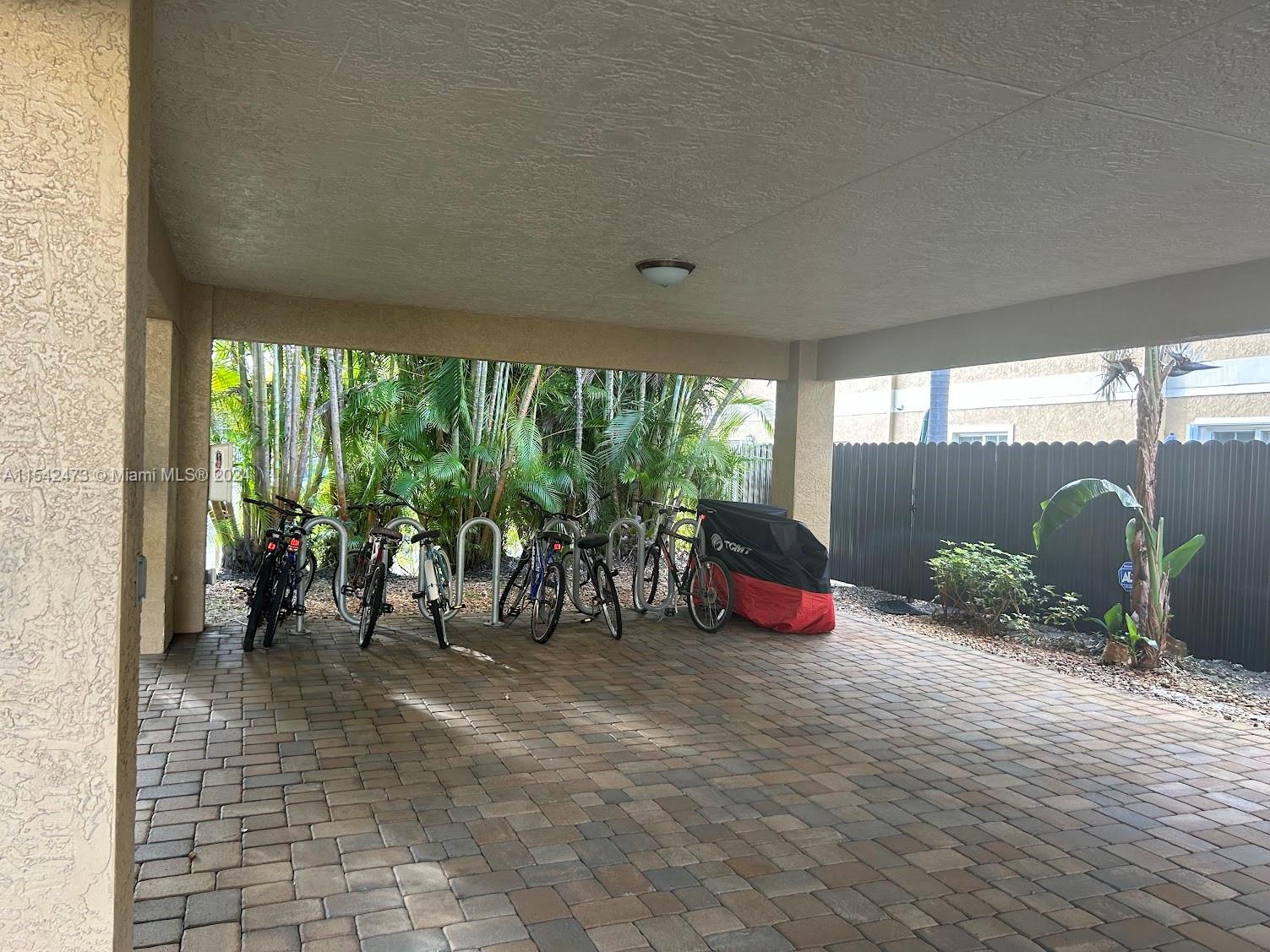 4802 Washington Street, Unit 5 Hollywood, FL 33021 - Photo 18 of 20 a view of a chairs and table in patio with a yard