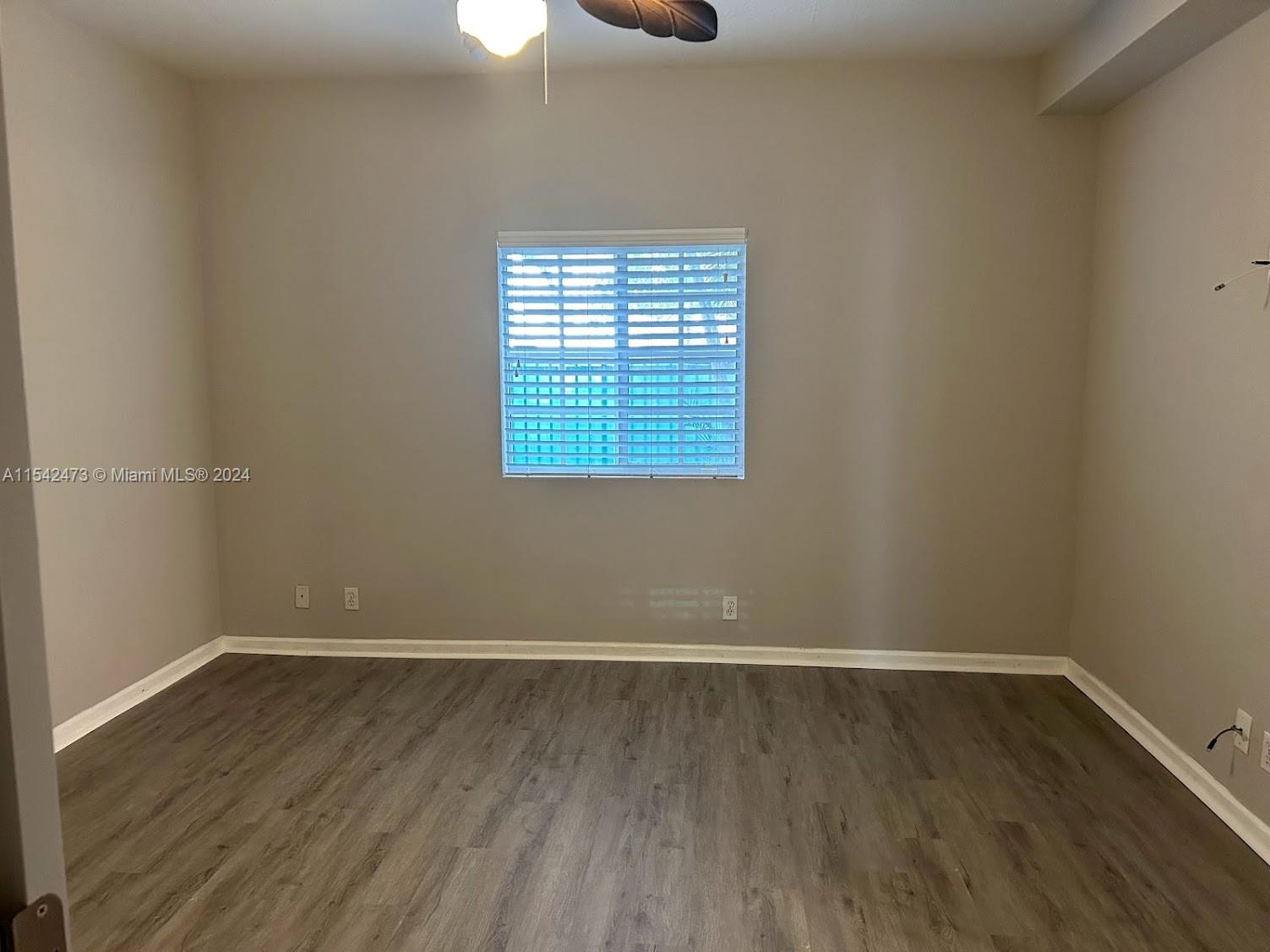 4802 Washington Street, Unit 5 Hollywood, FL 33021 - Photo 10 of 20 wooden floor in an empty room with a window