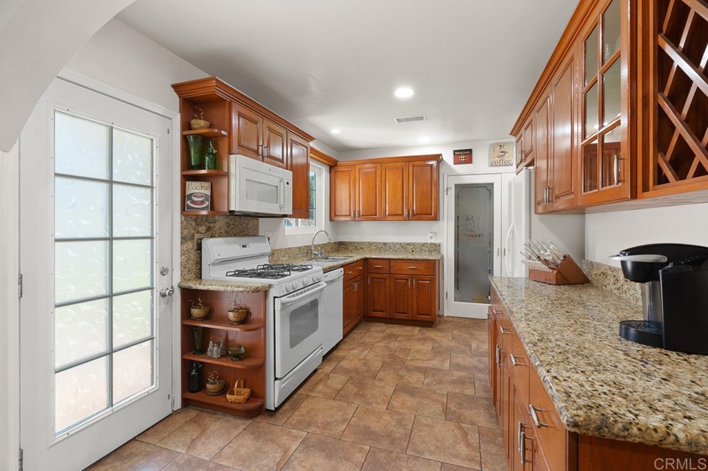 3335 Fairway Drive La Mesa, CA 91941 - Photo 12 of 30 a kitchen with stainless steel appliances granite countertop a stove a sink and a refrigerator