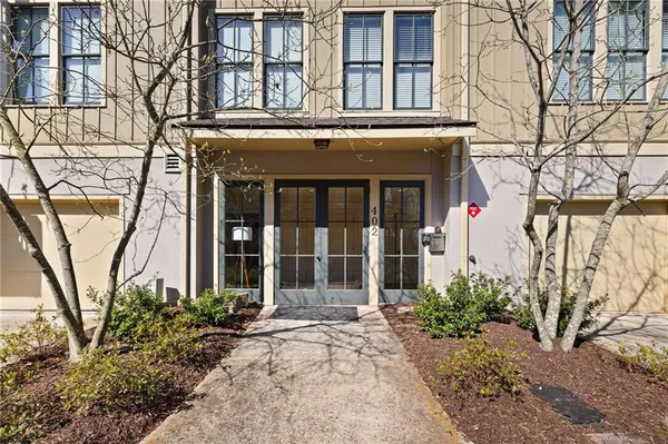front view of a brick house with a large window