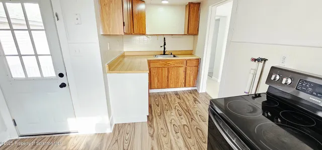 a kitchen with a sink stove and cabinets