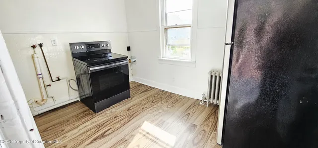 a view of kitchen and wooden floor