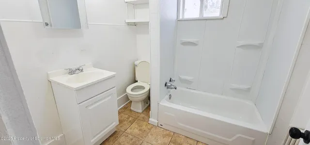 a bathroom with a sink toilet and bathtub