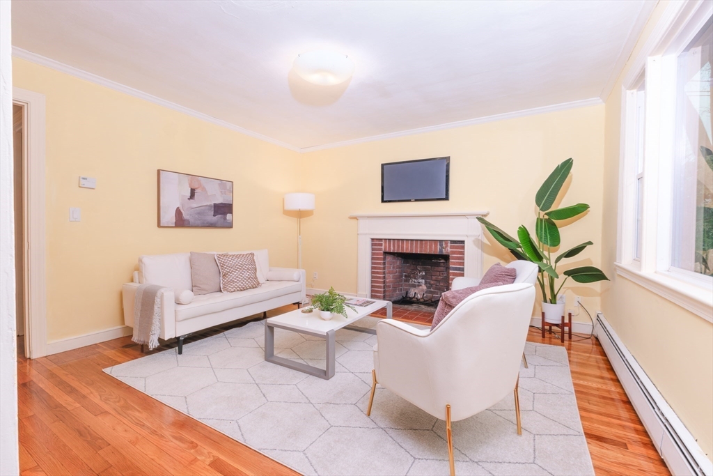 2096 Washington Street Newton, MA 02468 - Photo 3 of 13 a living room with furniture a fireplace and a potted plant