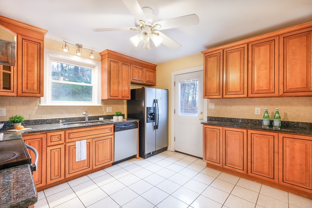 2096 Washington Street Newton, MA 02468 - Photo 7 of 13 a kitchen with stainless steel appliances granite countertop a stove sink and cabinets