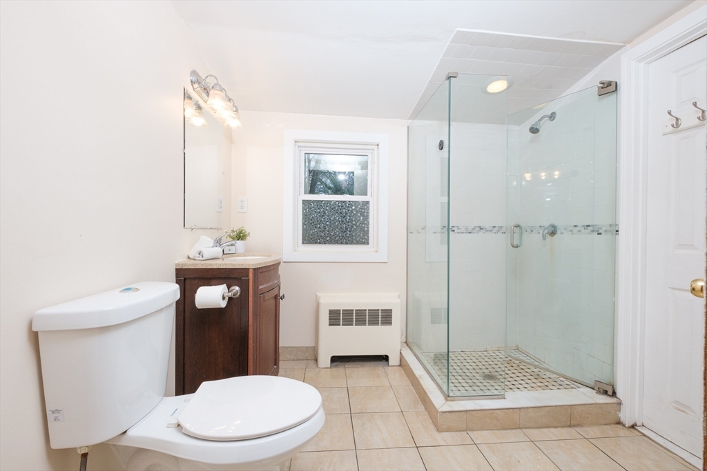 2096 Washington Street Newton, MA 02468 - Photo 10 of 13 a bathroom with a toilet a sink and shower