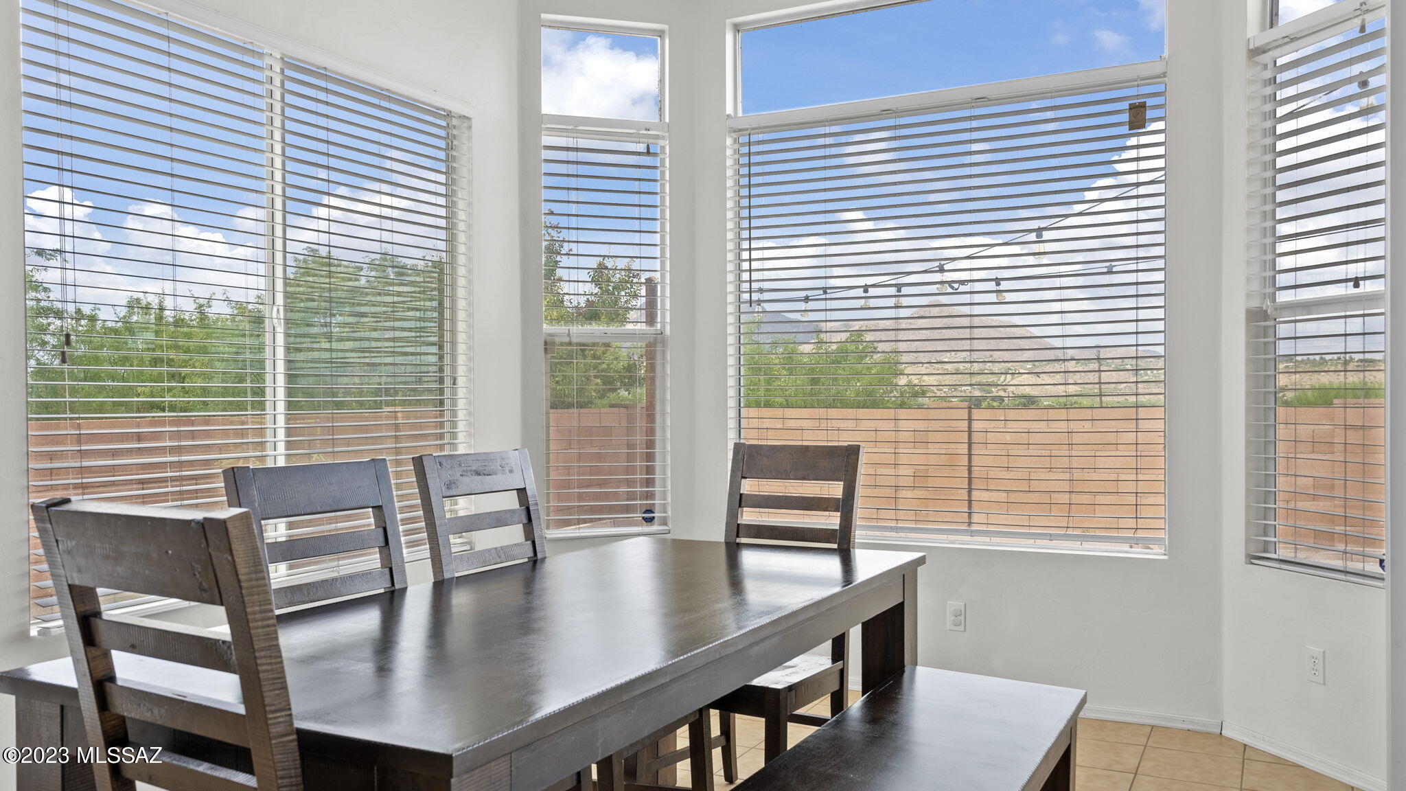 401 Via Capri Rio Rico, AZ 85648 - Photo 17 of 38 a view of a dining room with furniture and wooden floor