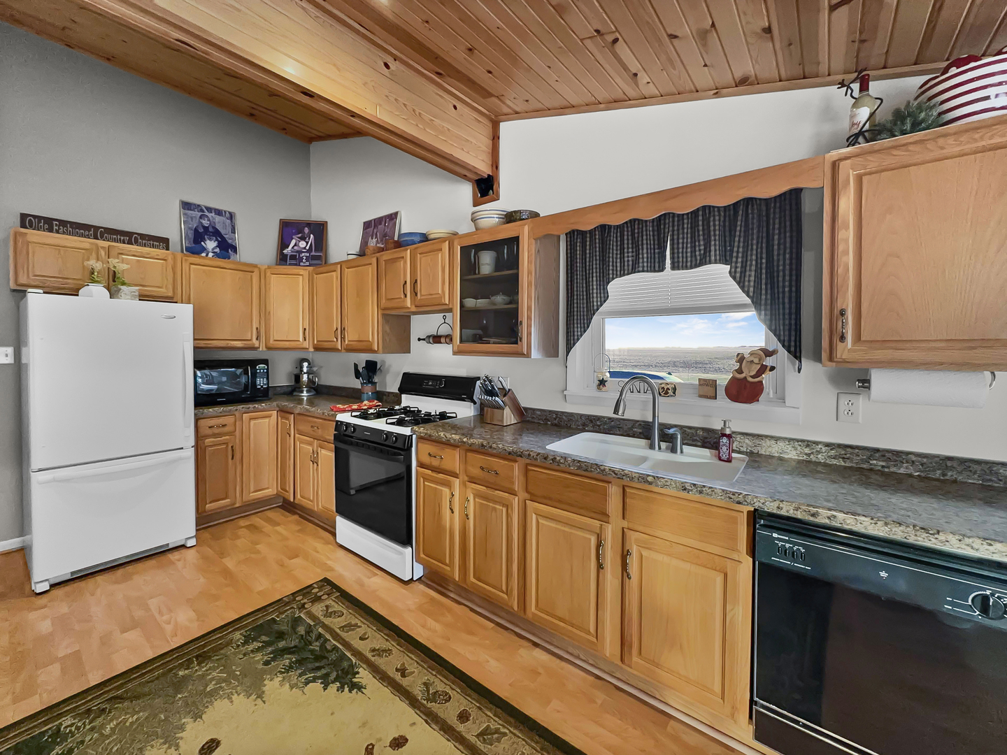 2604 East 1100 North Road Milford, IL 60953 - Photo 16 of 44 a kitchen with stainless steel appliances granite countertop a sink stove and refrigerator
