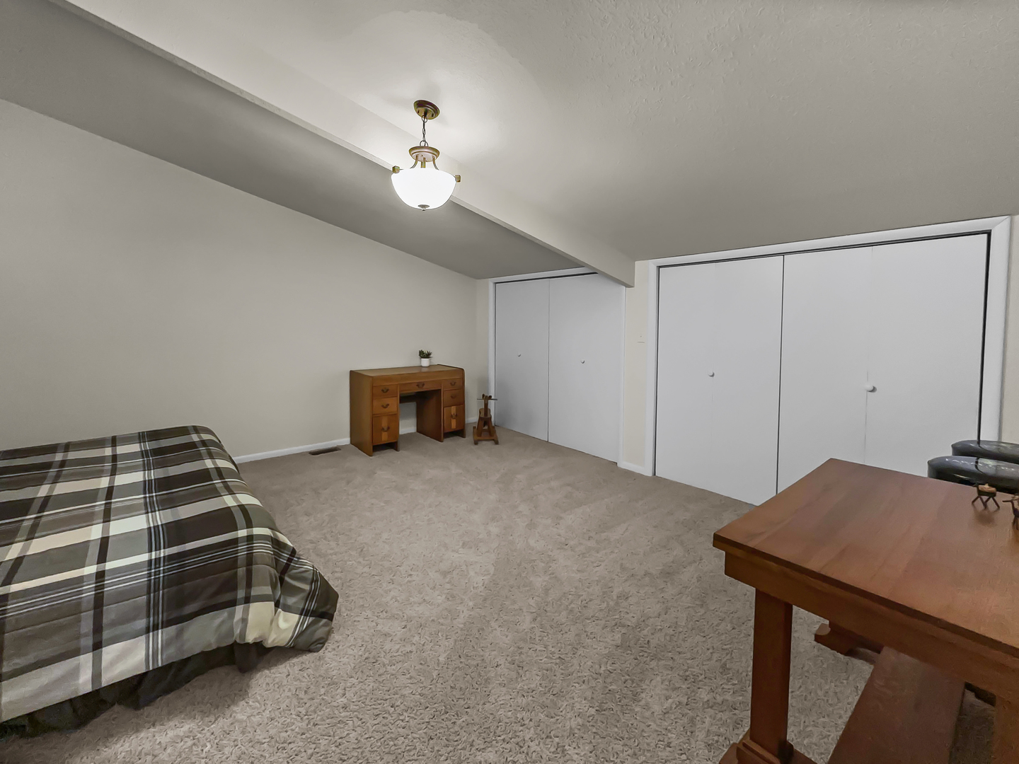 2604 East 1100 North Road Milford, IL 60953 - Photo 21 of 44 a bedroom with a bed and a chandelier