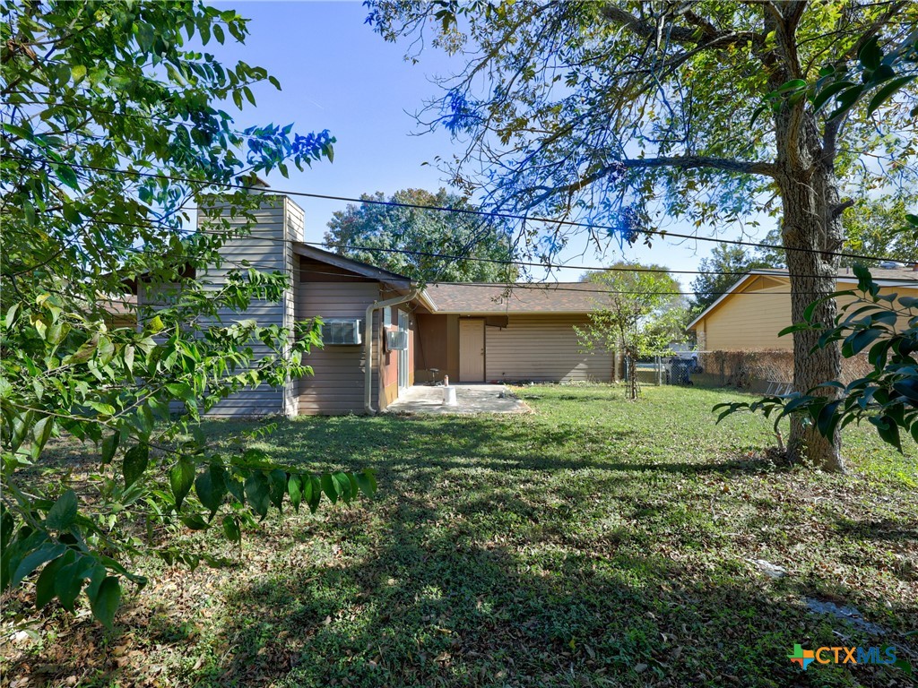 103 Lackey Street Florence, TX 76527 - Photo 11 of 39 a view of house with a yard and potted plants