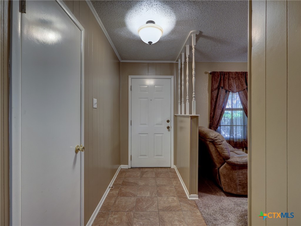 103 Lackey Street Florence, TX 76527 - Photo 15 of 39 a view of hallway with livingroom and stairs