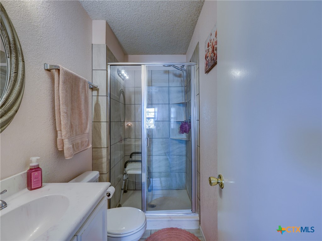 103 Lackey Street Florence, TX 76527 - Photo 27 of 39 a bathroom with a sink toilet and shower