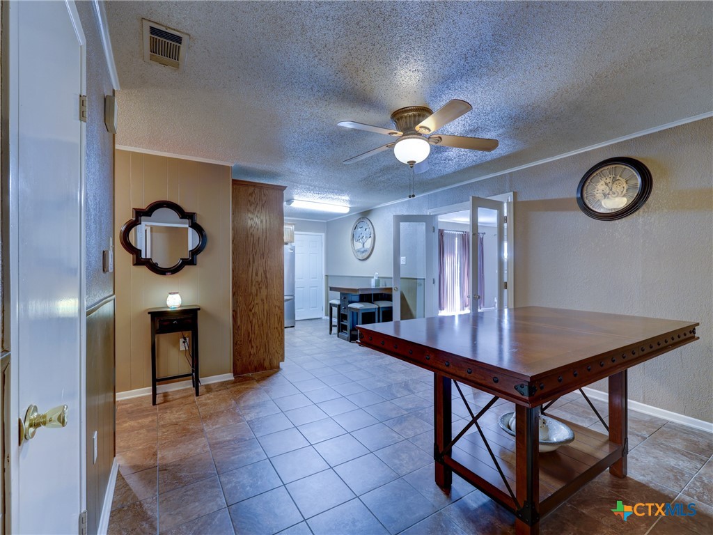 103 Lackey Street Florence, TX 76527 - Photo 28 of 39 a view of a room with furniture and chandelier fan