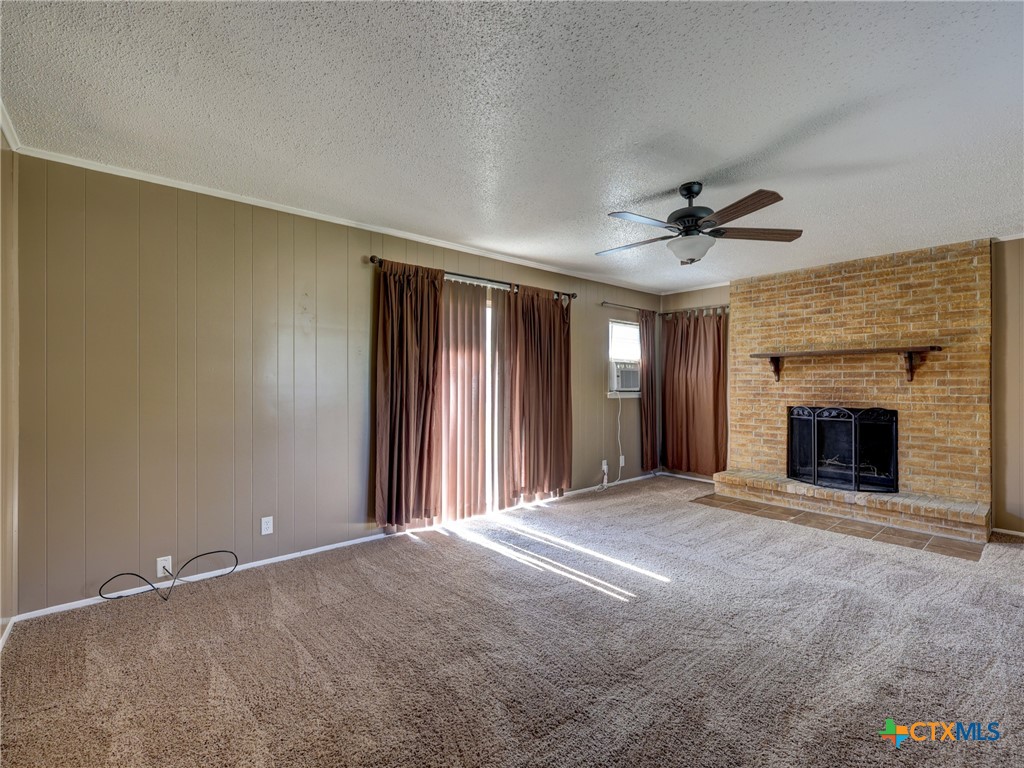 103 Lackey Street Florence, TX 76527 - Photo 34 of 39 a view of an empty room with a fireplace