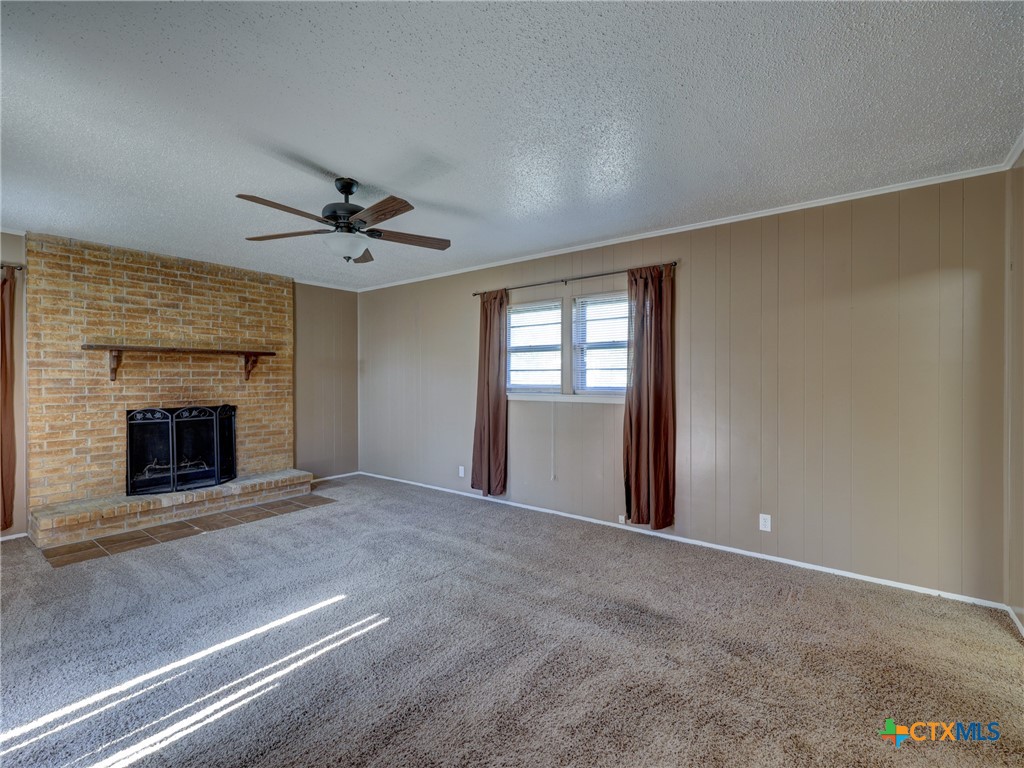 103 Lackey Street Florence, TX 76527 - Photo 35 of 39 an empty room with windows and fireplace